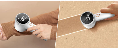 Handheld electronic device with digital display being used on a person's arm.