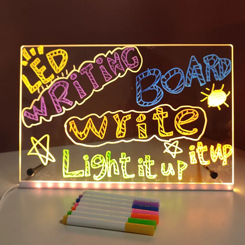 LED writing board with colorful markers on a dark background