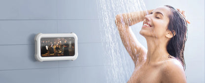 Woman showering with phone holder mounted on the wall displaying a movie.