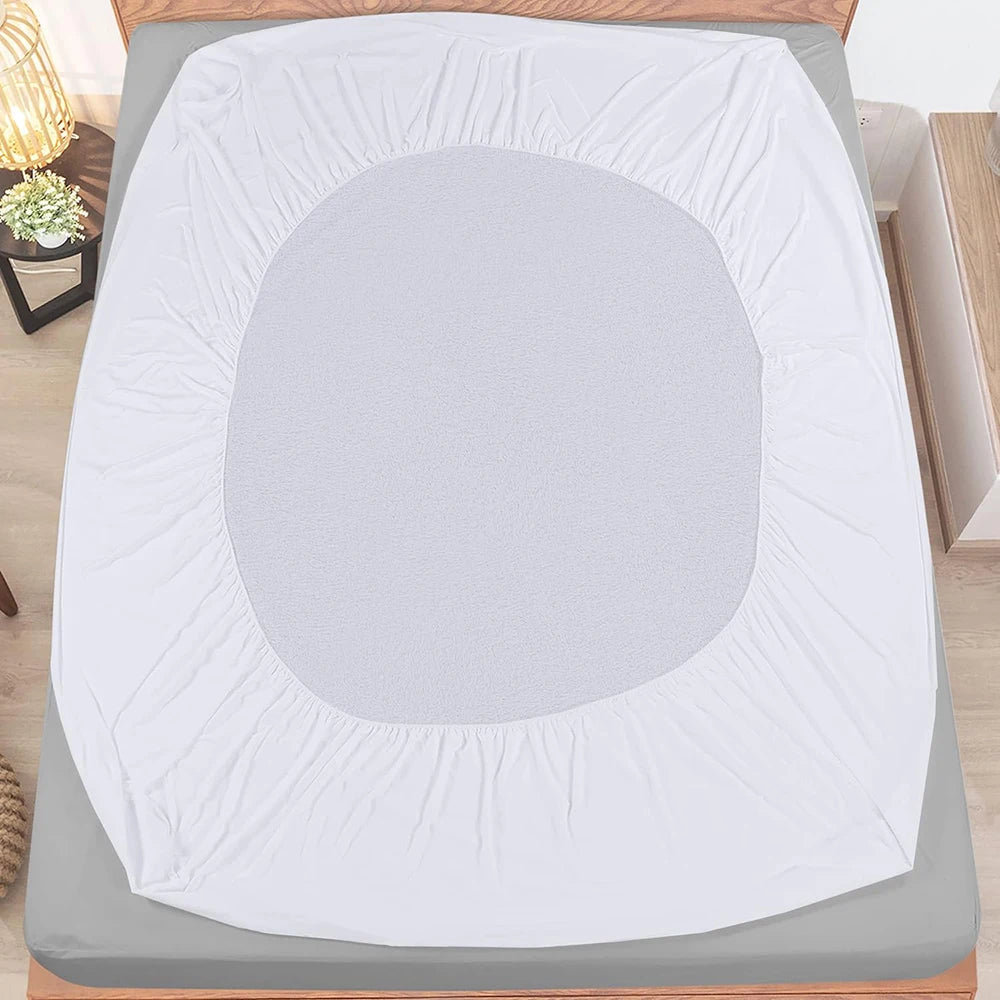 White fitted sheet on a bed in a bedroom setting